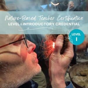 Person holds dry materials and blows to start a fire. The flame is visible. This advertises the Nature-Based Teacher Certification course for the Association for Nature-Based Education.